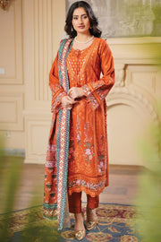 Woman wearing an orange embroidered outfit with a patterned scarf indoors.
