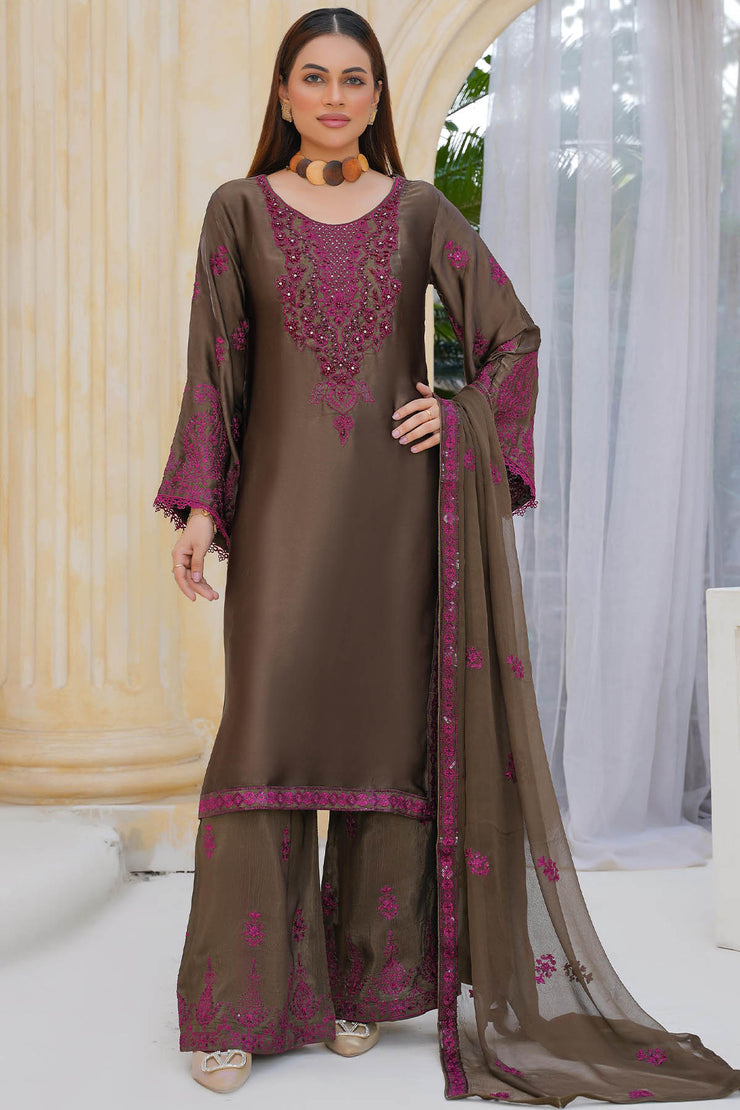 Woman wearing a brown and purple embroidered traditional outfit with a sheer dupatta.